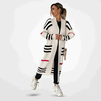 Claire striped longline cardigan in white with black stripes and pink accent, worn open over black outfit, front view