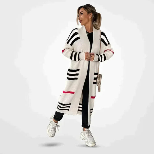 Claire striped longline cardigan in white with black stripes and pink accent, worn open over black outfit, front view