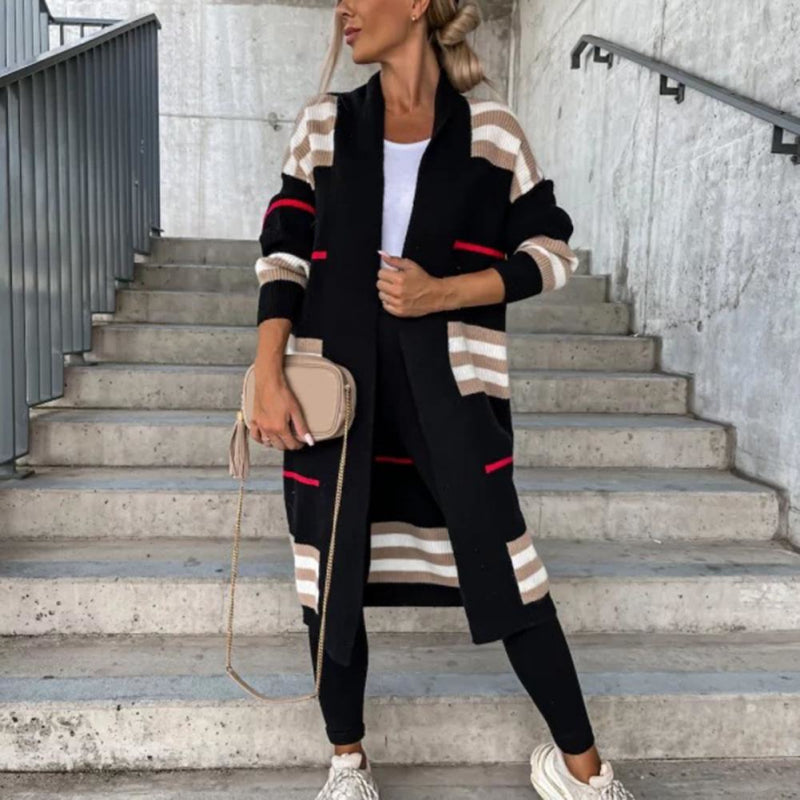 Claire striped longline cardigan in black colourblock stripe, styled on stairs with crossbody bag