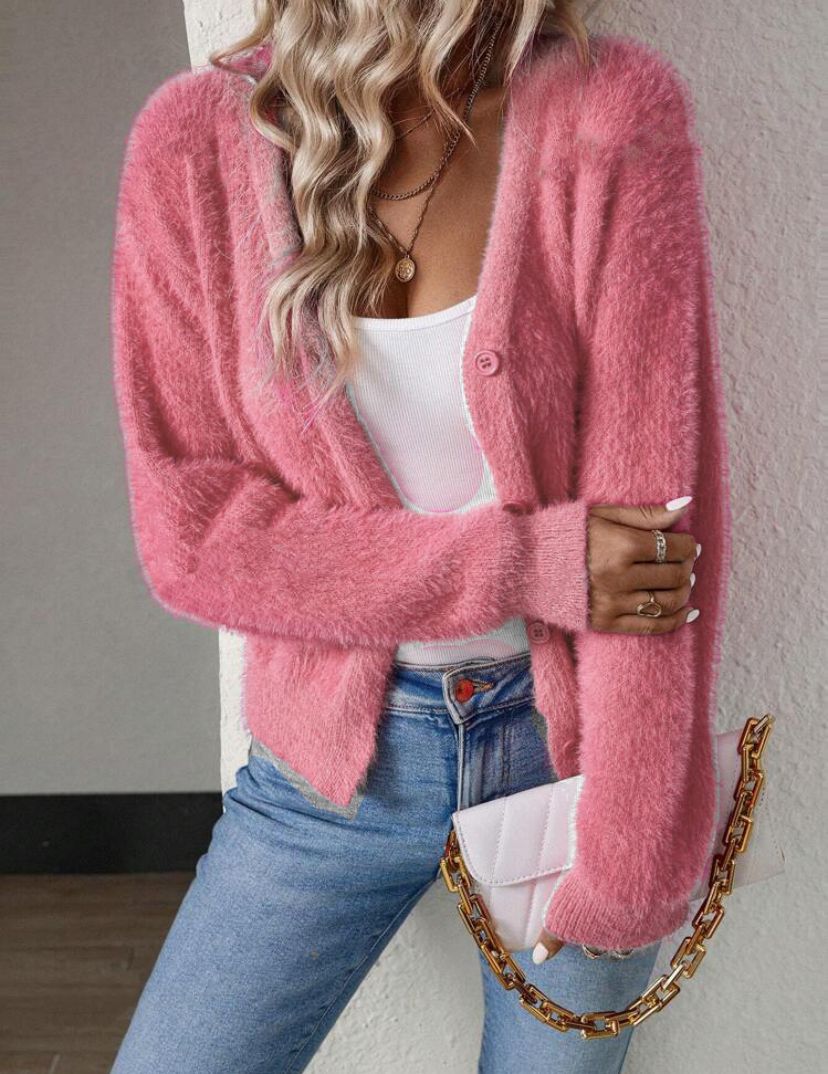 Pink fluffy knit cardigan worn open over white tank top, front view