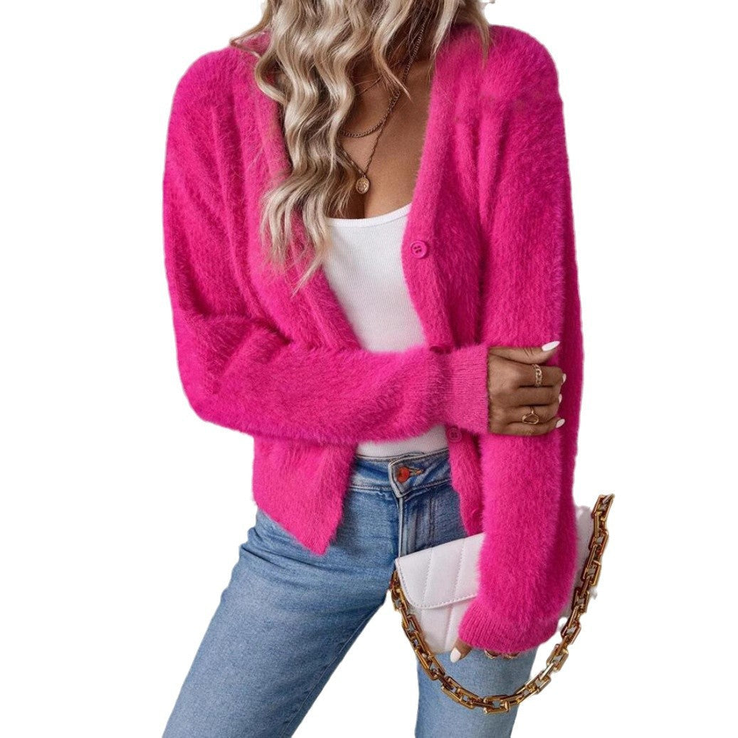 Pink fluffy knit cardigan worn open with white tank top and crossbody bag