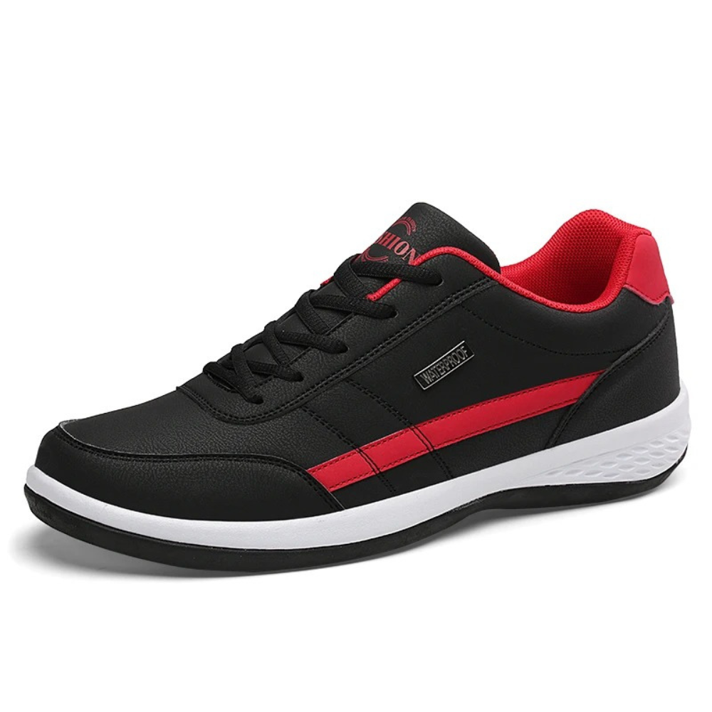 Navy leather trainer with tan stripe detail, studio product shot