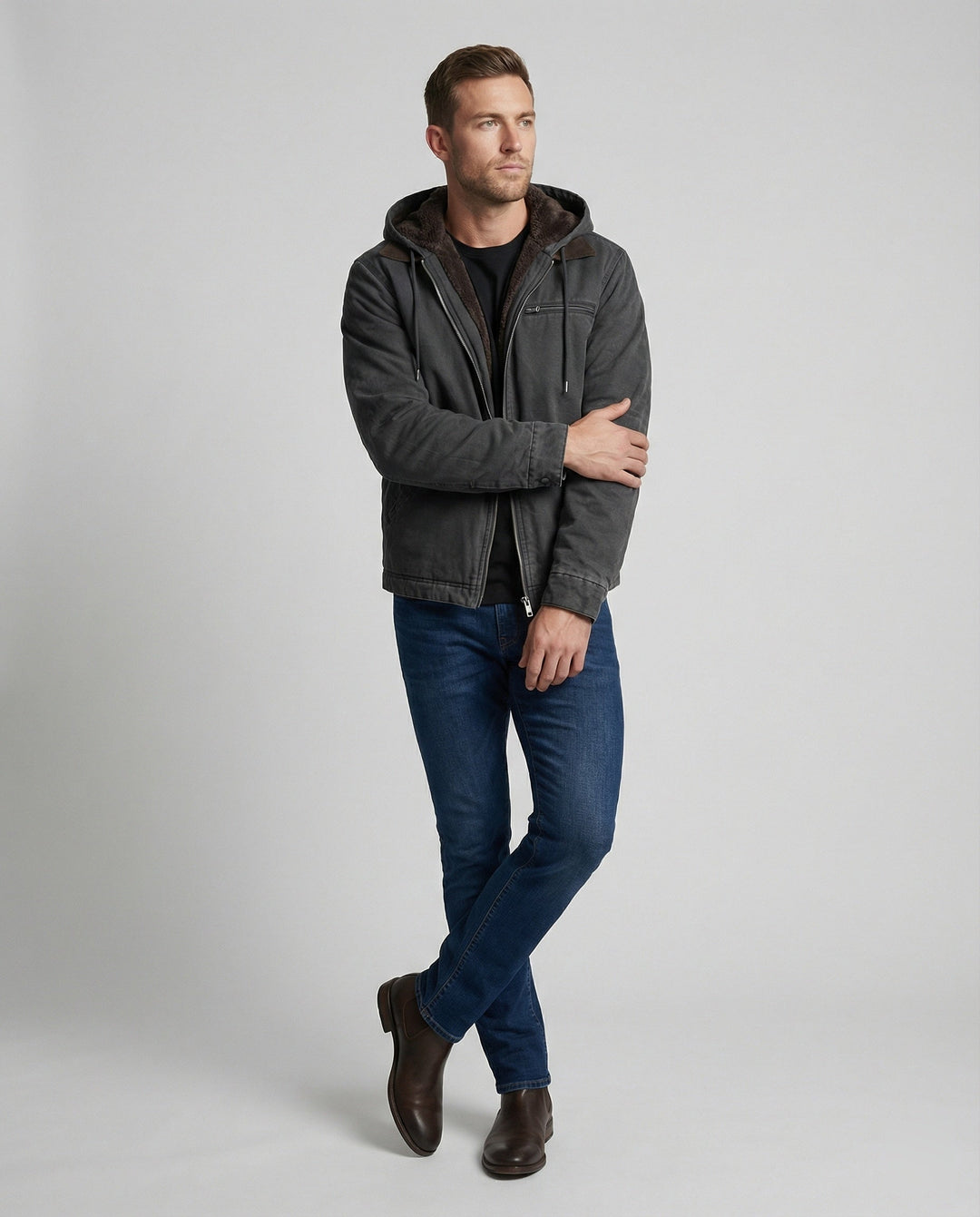 Full-length front view of man wearing Harvey jacket with jeans and boots