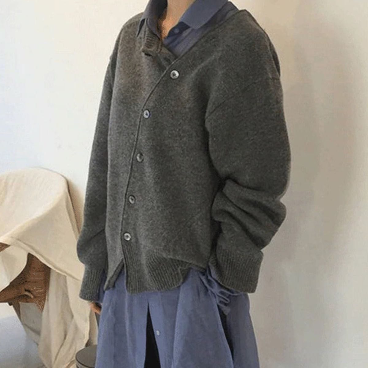 Hazel asymmetric button cardigan, side view over collared shirt