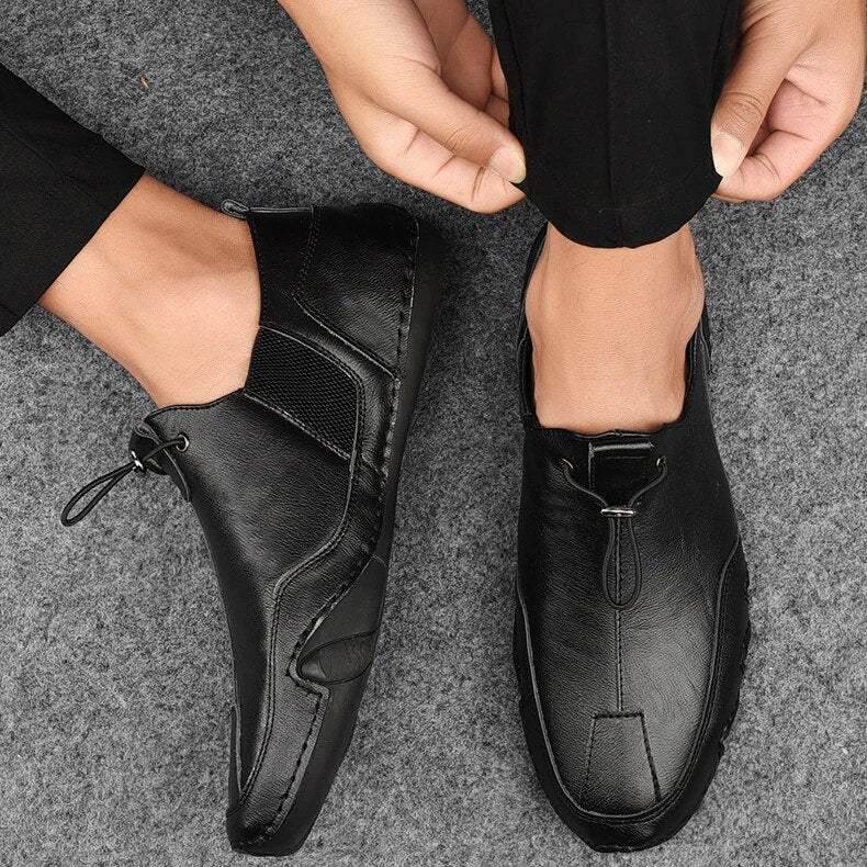 Jasper leather slip-on trainers worn with trousers, close-up top view