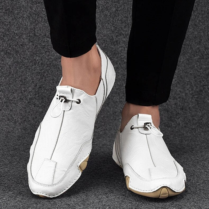 Jasper leather slip-on trainers worn with cropped trousers, side view