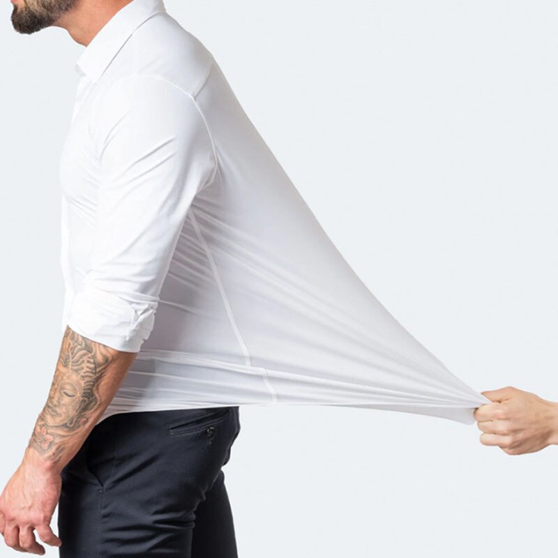 Model stretching the fabric of the white Julian shirt at the side to show stretch