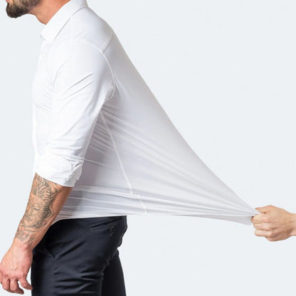 Model stretching the fabric of the white Julian shirt at the side to show stretch
