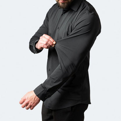 Model stretching the sleeve fabric of the black Julian shirt to show elasticity