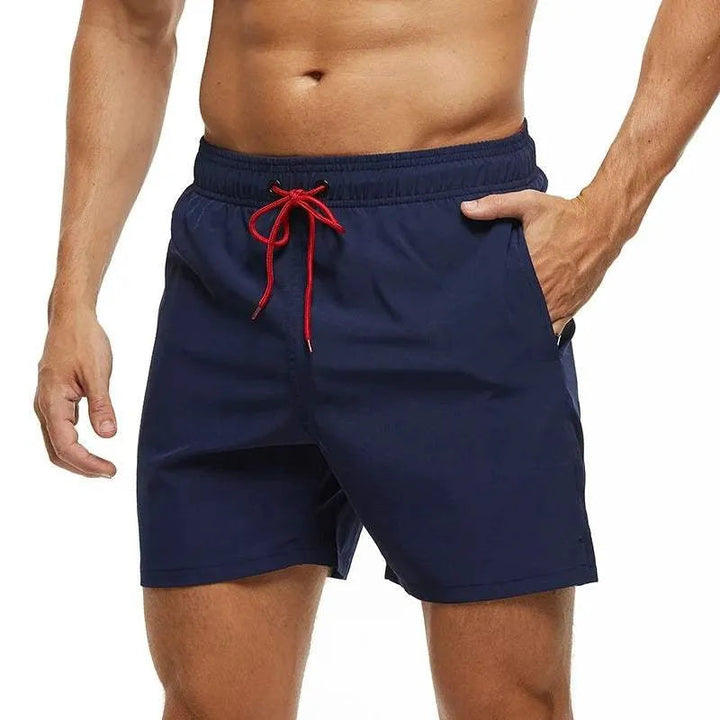 Kai navy swim shorts with red drawstring, front view