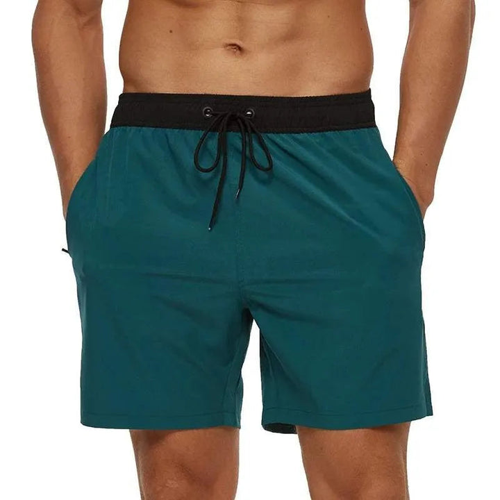 Kai dark teal swim shorts with black waistband, front view