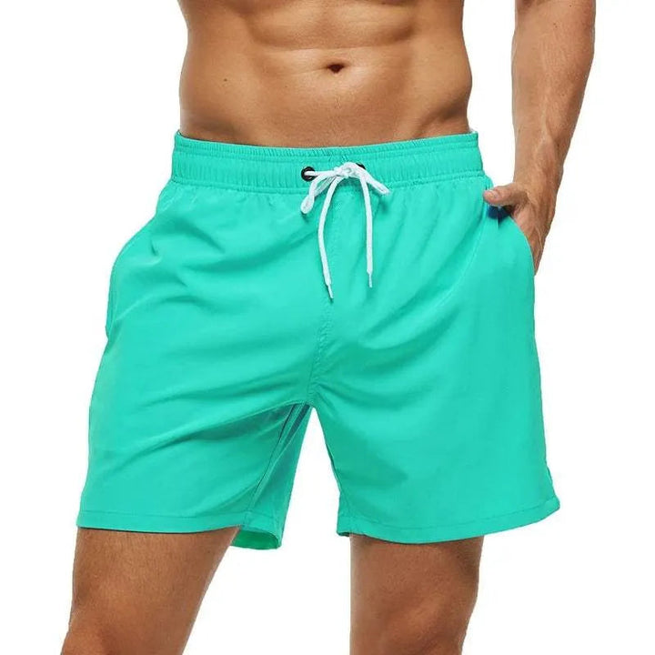 Kai turquoise swim shorts with white drawstring, front view