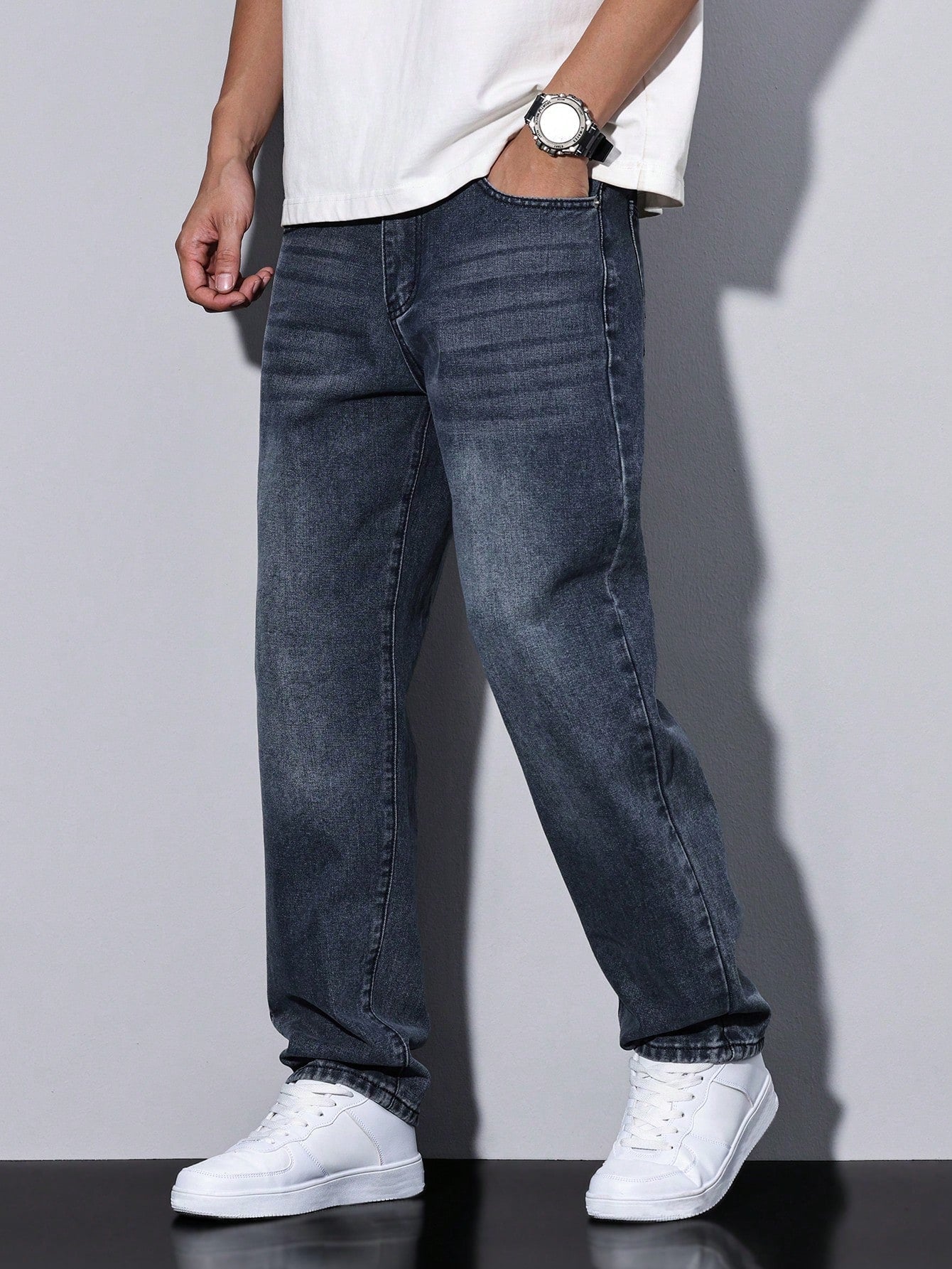 Lars men's washed straight leg jeans in dark blue-grey, side view with hand in pocket