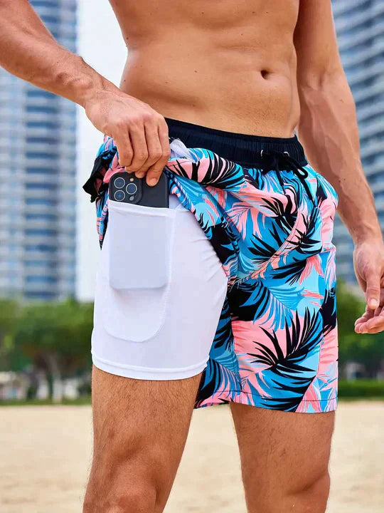 Noah tropical leaf print swim shorts, side view with phone in hidden pocket