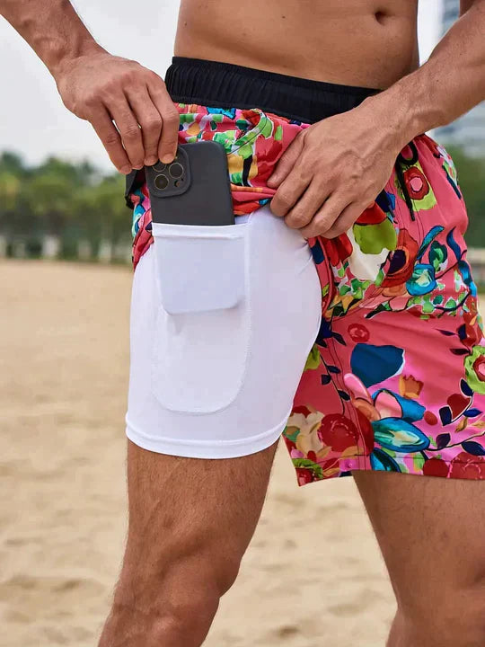 Noah pink floral print swim shorts, side view with phone in hidden pocket