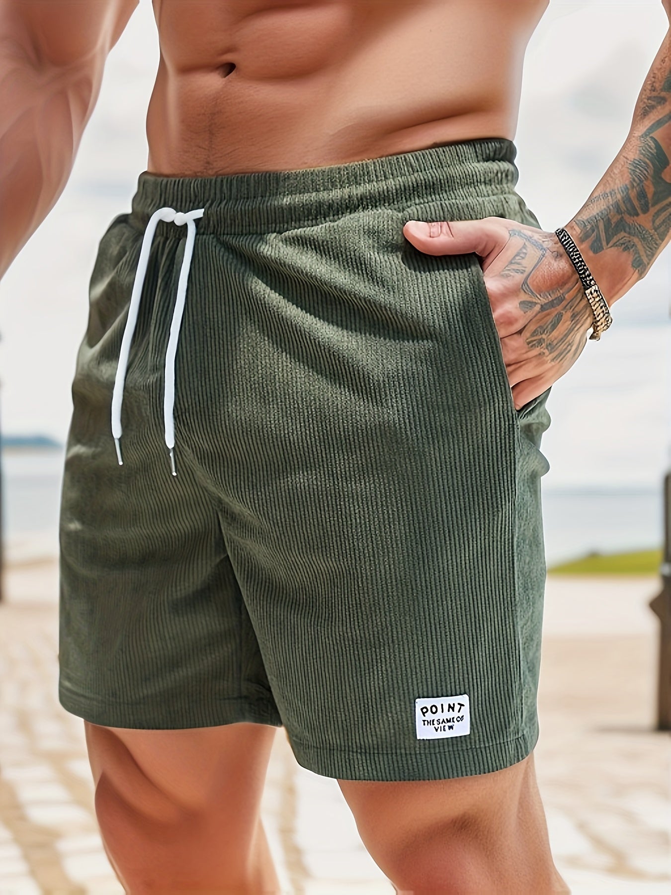 Theo ribbed corduroy shorts in green, front view with hand in pocket