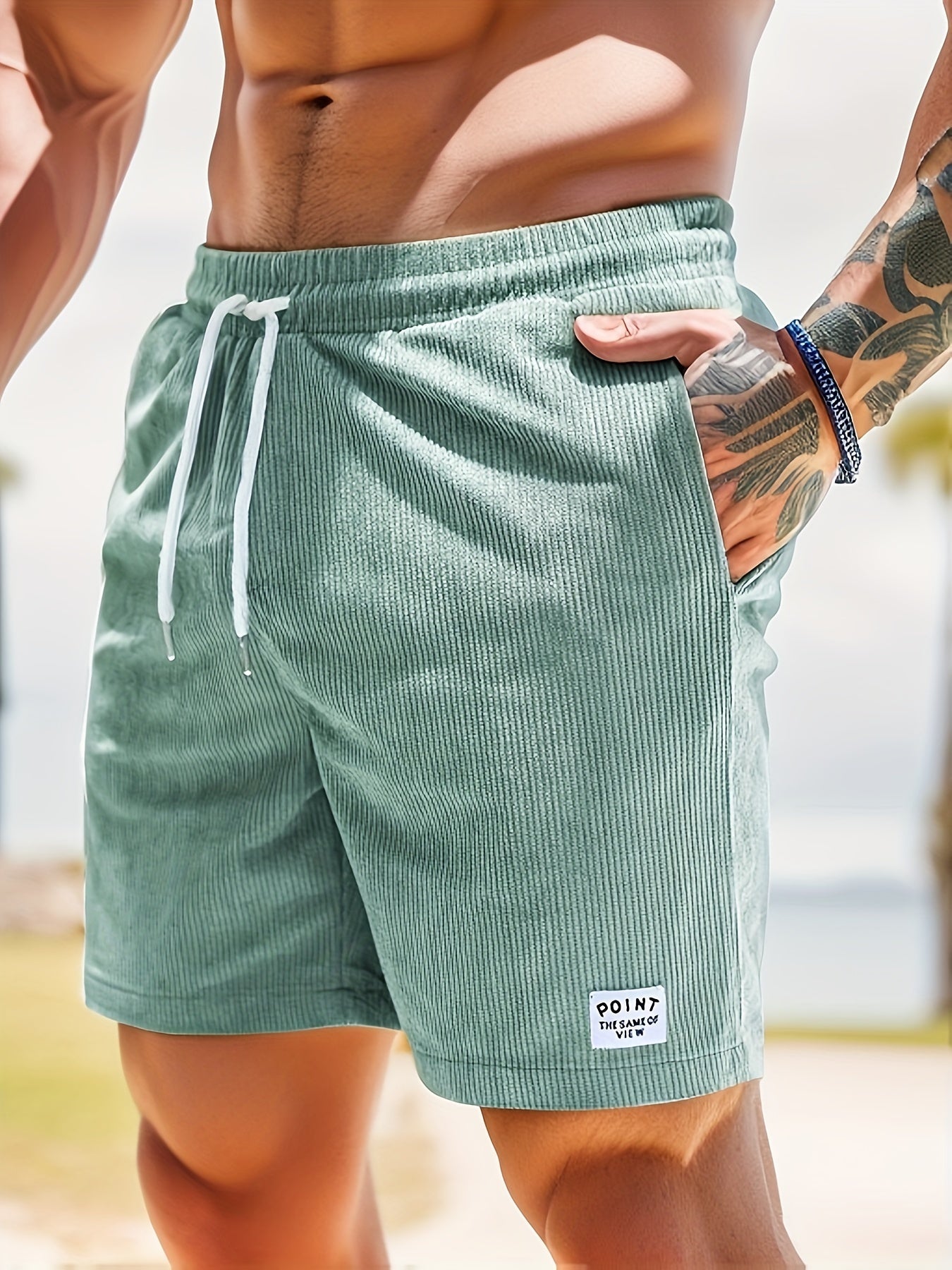 Theo ribbed corduroy shorts in sage green, side view with hand in pocket