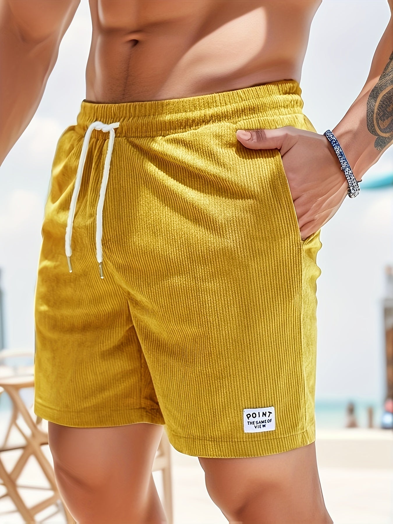 Theo ribbed corduroy shorts in yellow, side view with hand in pocket