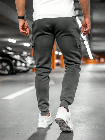 Tom cargo jogger trousers, back view walking in dark grey